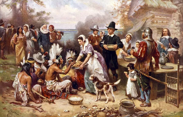 The first Thanksgiving, 1621, Pilgrims and natives gather to share a meal, oil painting by Jean Louis Gerome Ferris, 1932. - image by Everett Historical/shutterstock.com